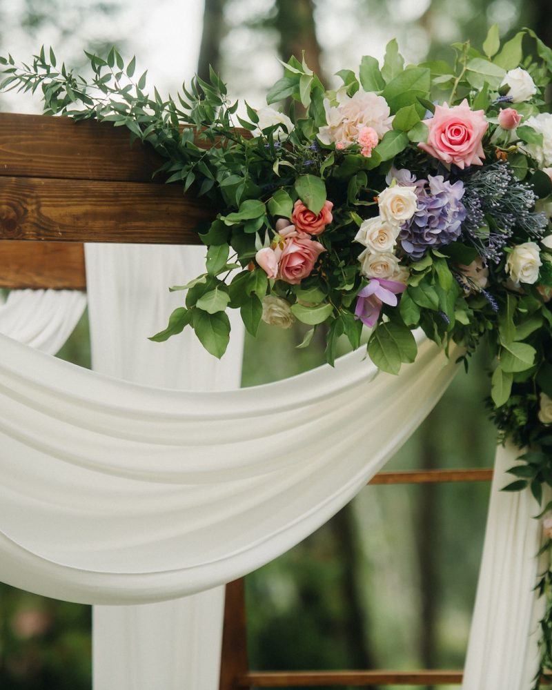 wedding-ceremony-on-the-street-on-the-green-lawn-decor-with-fresh-flowers-arches-for-the-ceremony.jpg